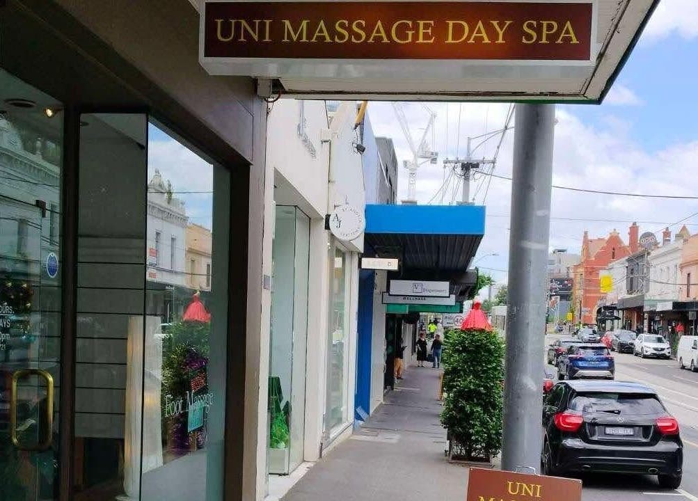 Entrance to Uni Massage Day Spa in Melbourne, Victoria, AU on a sunny street view.