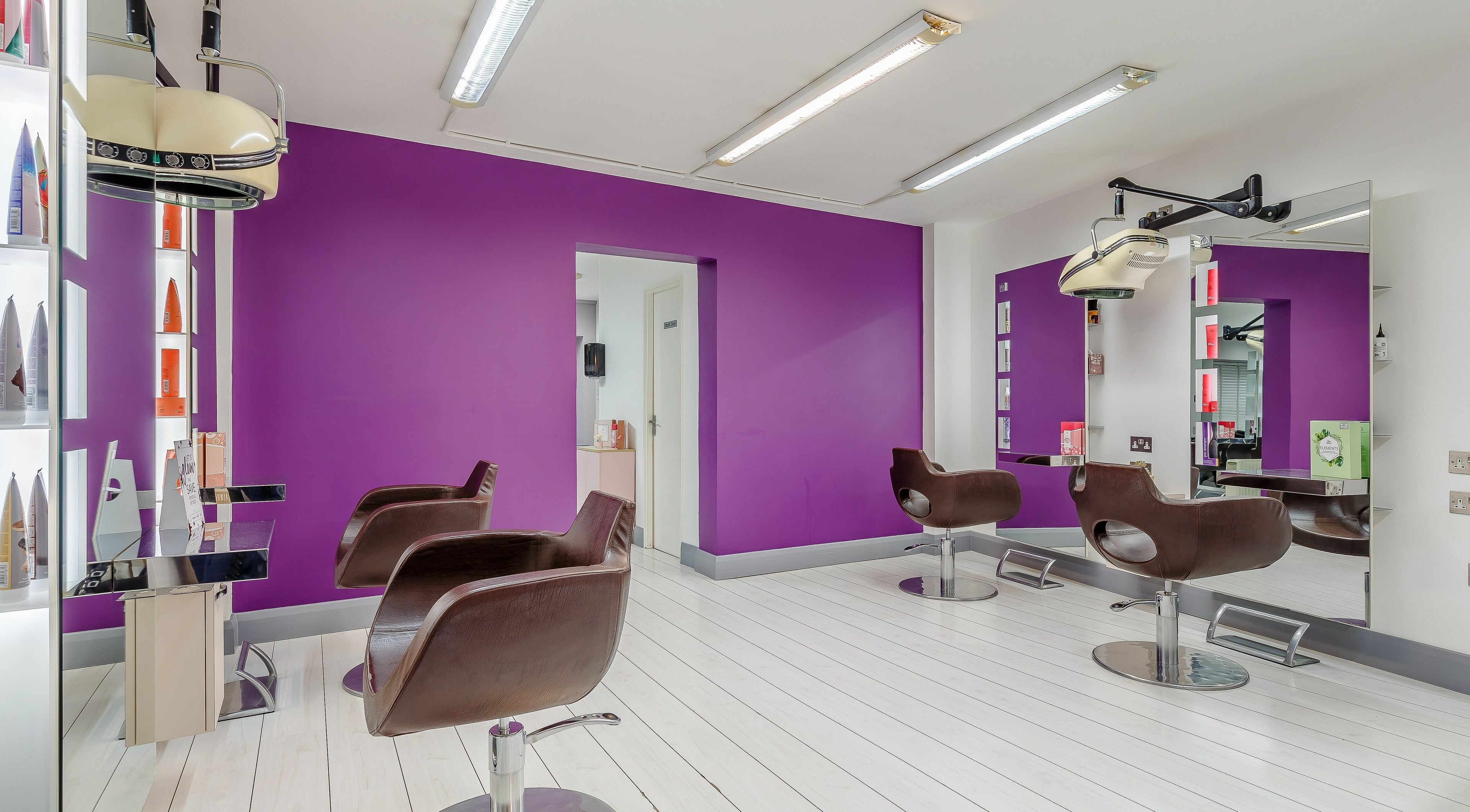 Modern salon interior with purple accents at Integrity Hair Design in Truro, England, GB.