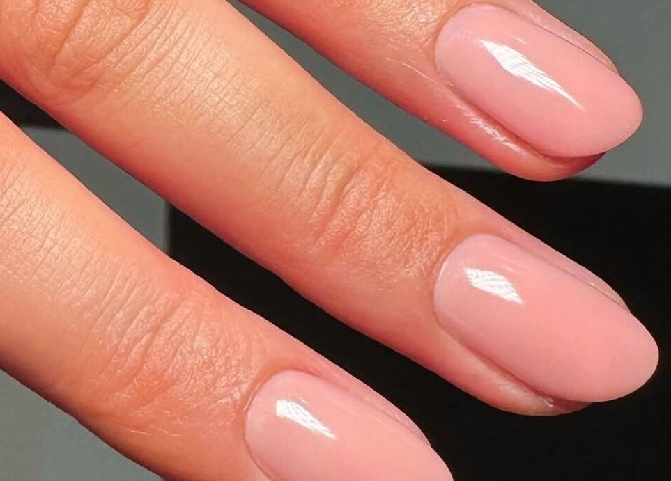 Manicured nails with glossy pink finish at By Lennon Beauty & Waxing, Edinburgh, Scotland, GB.