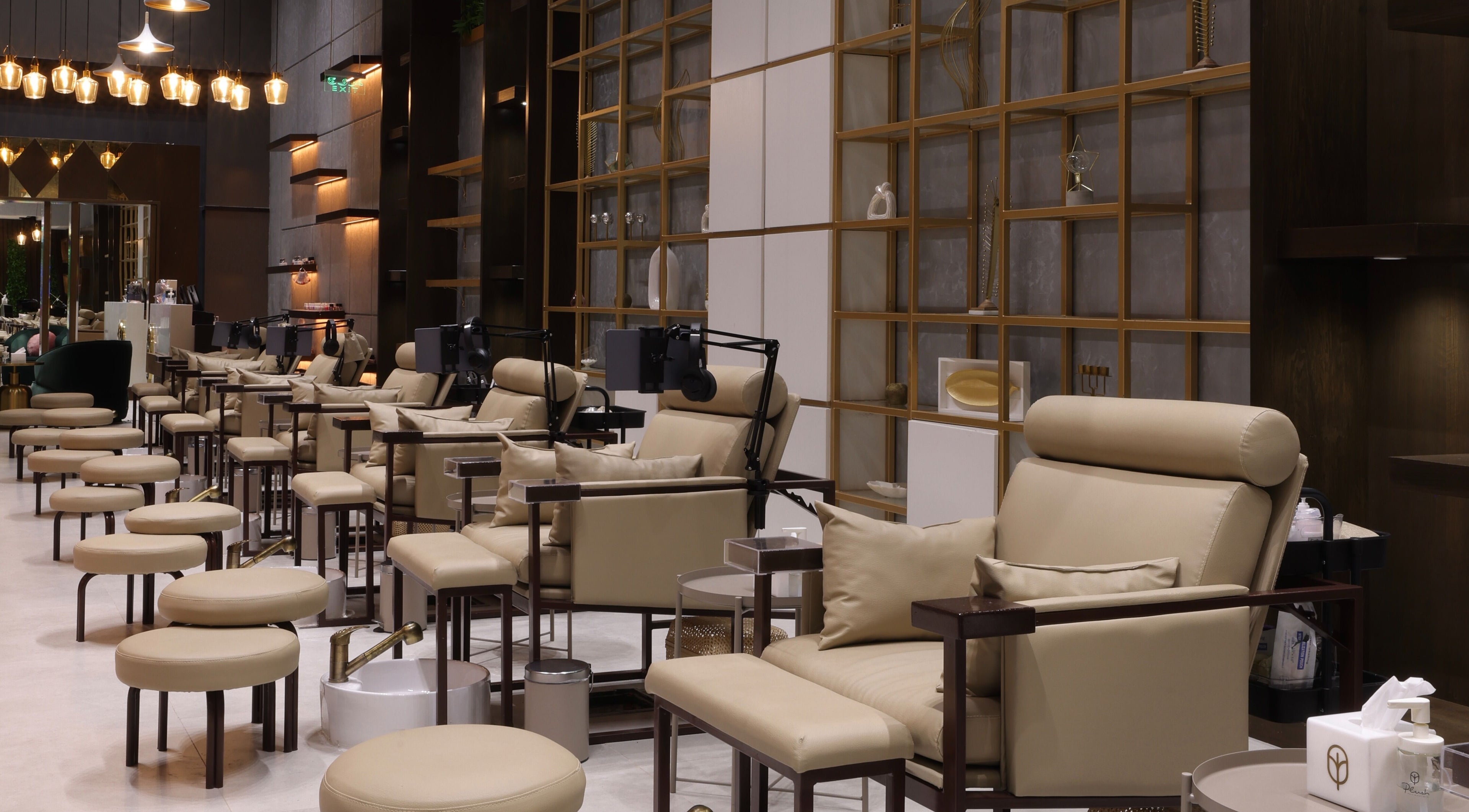 Luxurious seating at Plush Nail Boutique - As Sulimaniyah in Riyadh, SA, showcasing elegant nail care stations.