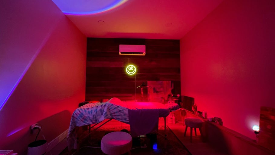 Relaxing spa room at Elevate Wellness - Allison Best, LMT in Belpre, Ohio, US with calming red lighting.