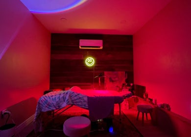 Relaxing spa room at Elevate Wellness - Allison Best, LMT in Belpre, Ohio, US with calming red lighting.