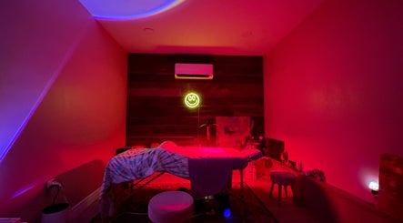 Relaxing spa room at Elevate Wellness - Allison Best, LMT in Belpre, Ohio, US with calming red lighting.