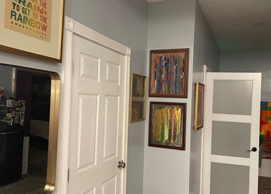 Art-filled hallway at Elevate Wellness - Allison Best, LMT in Belpre, Ohio, US showcasing colorful framed artworks.