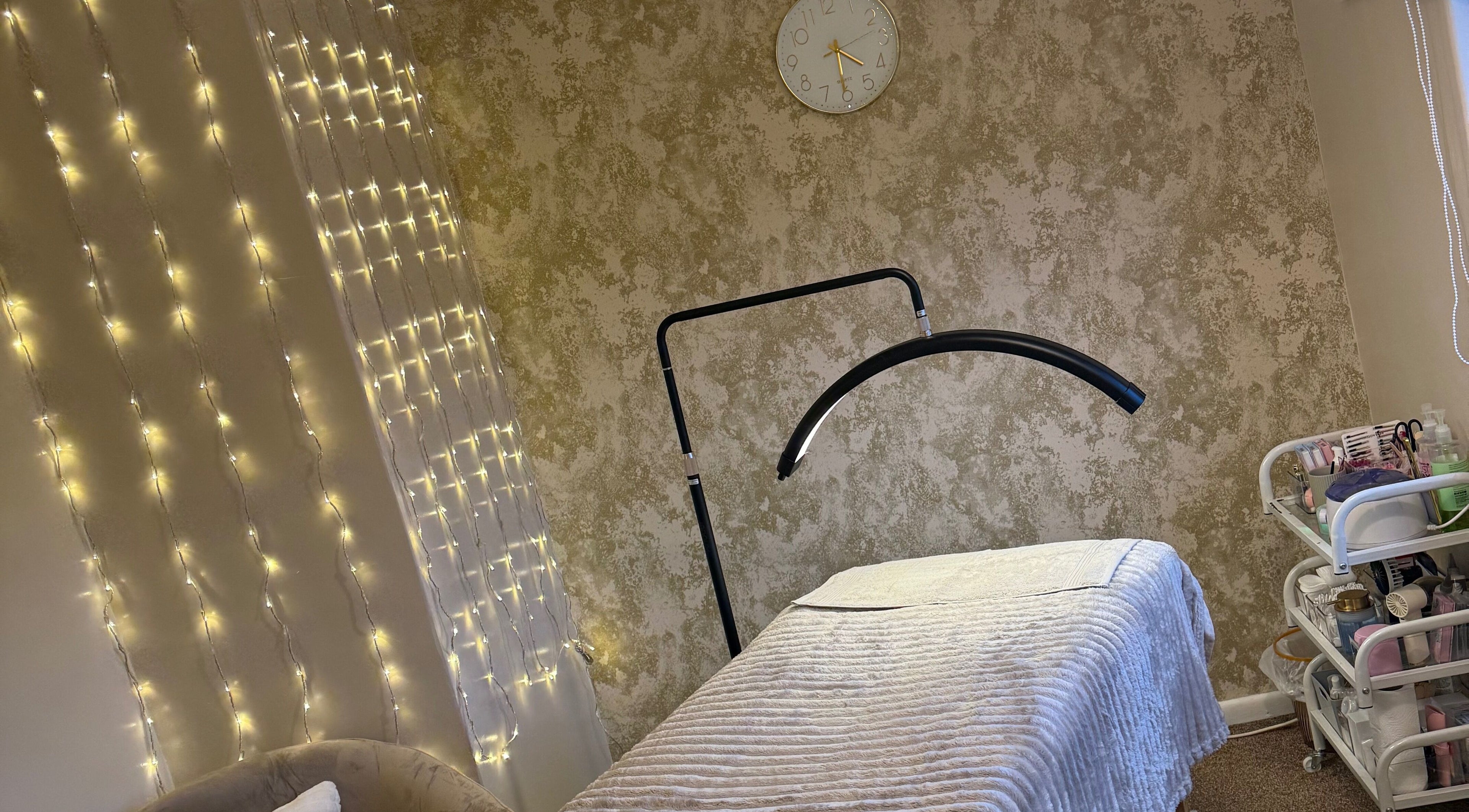 Beauty by Olivia Zoe therapy room in Seaton, England, GB with warm lighting and a spa bed.