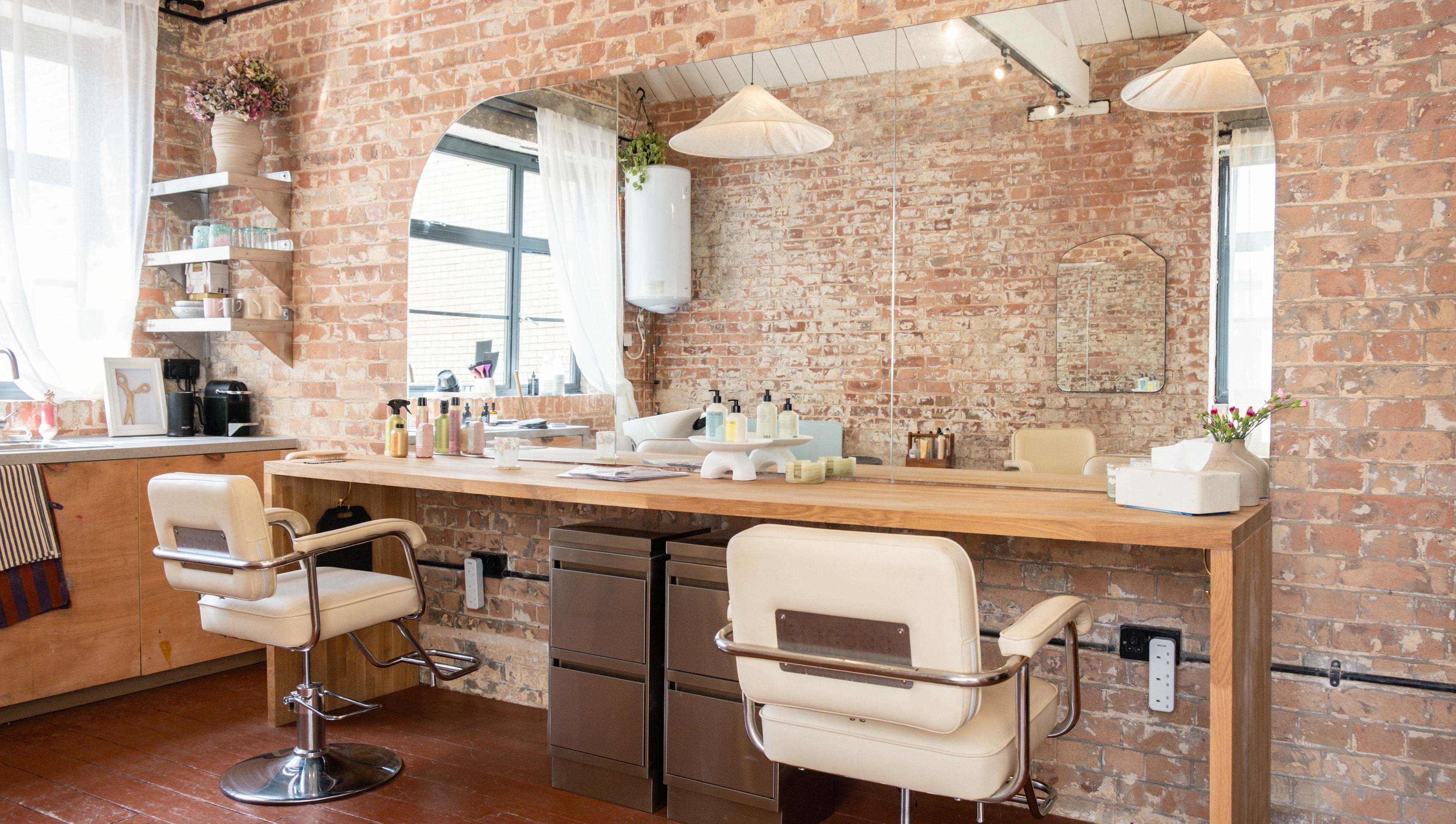 Modern salon interior with brick walls at Fluff.Hackney, London, England, GB.