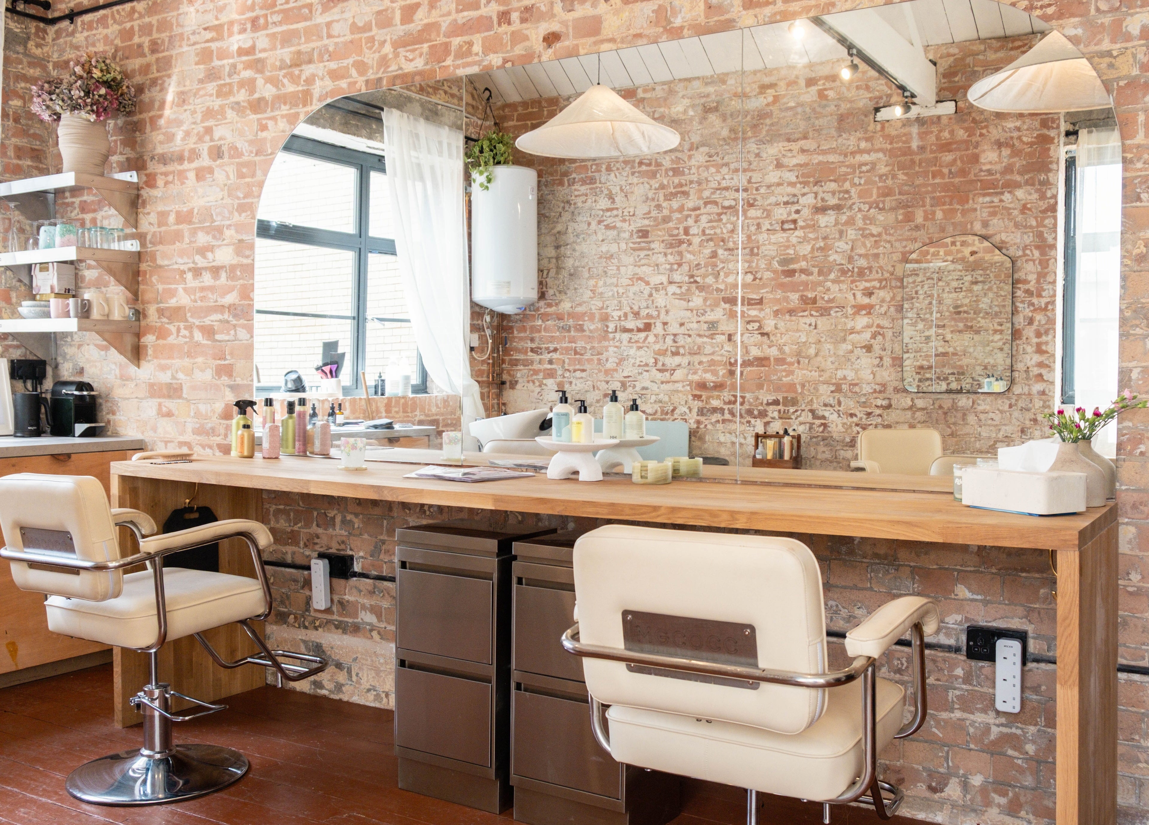 Modern salon interior with brick walls at Fluff.Hackney, London, England, GB.