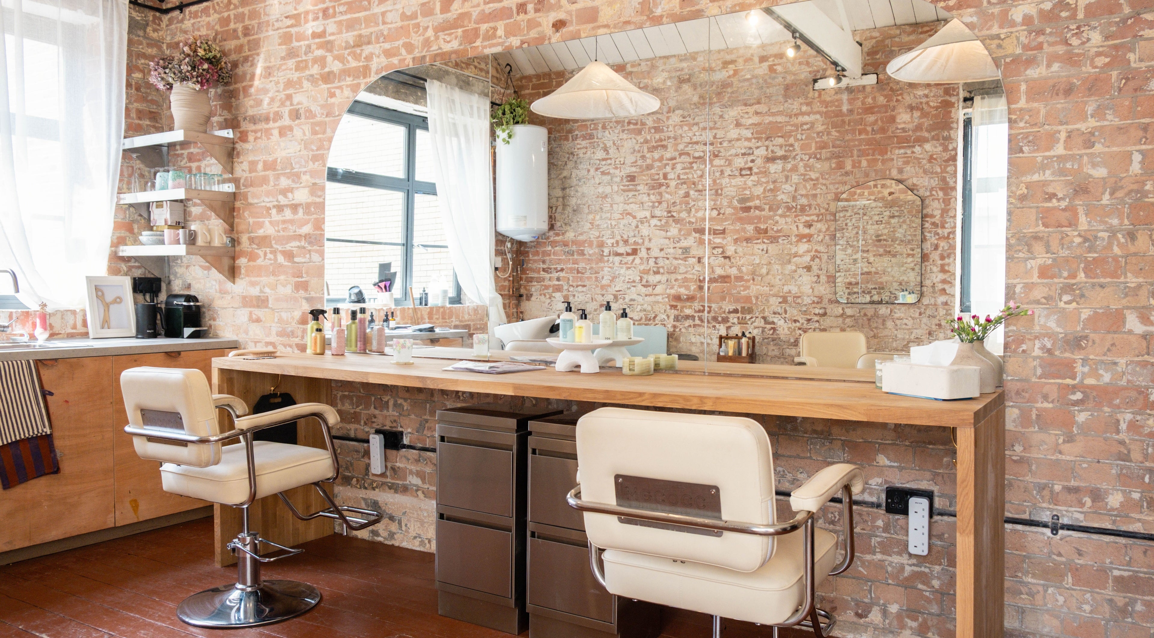 Modern salon interior with brick walls at Fluff.Hackney, London, England, GB.