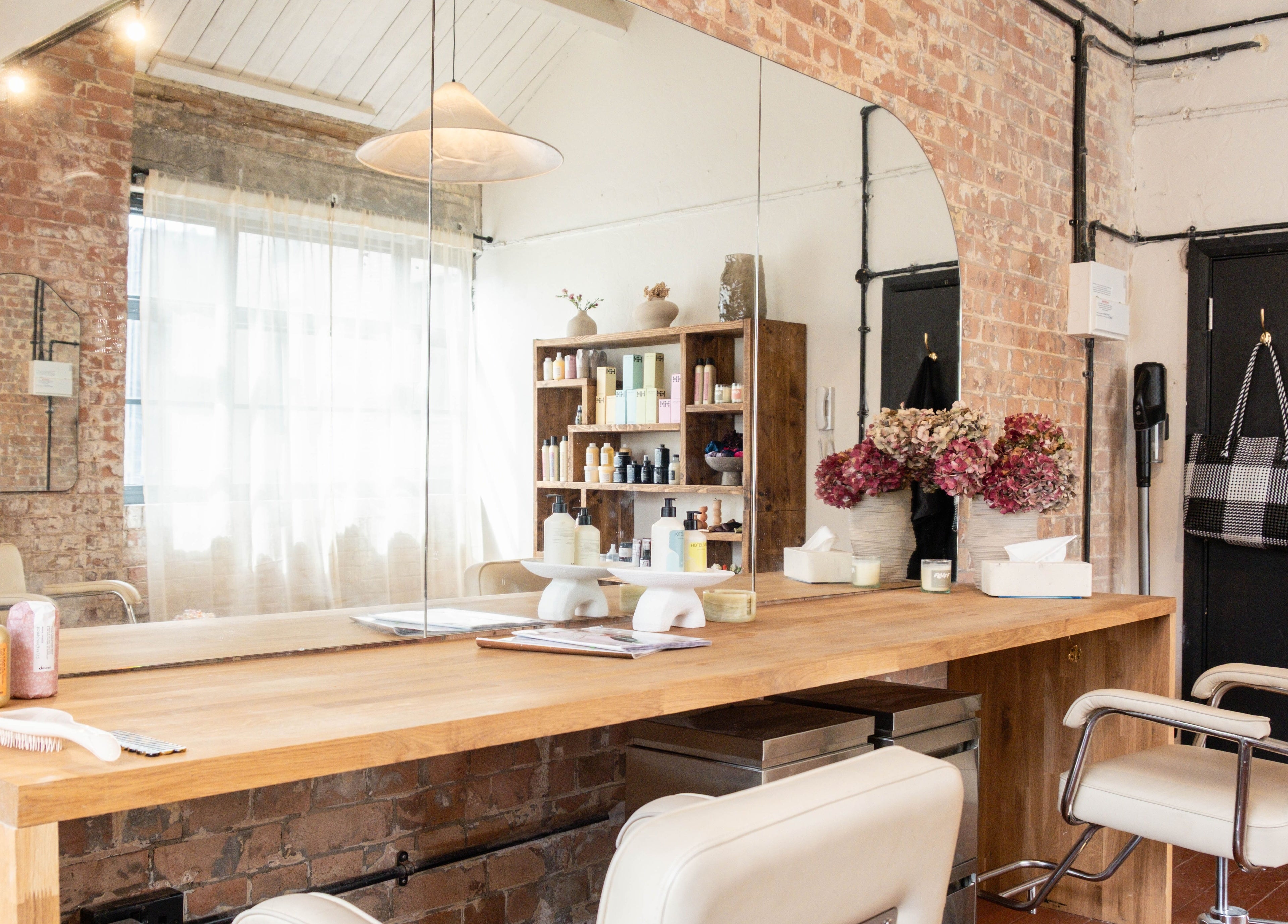 Elegant styling station at Fluff.Hackney, London, England, GB with plush chairs and modern decor.