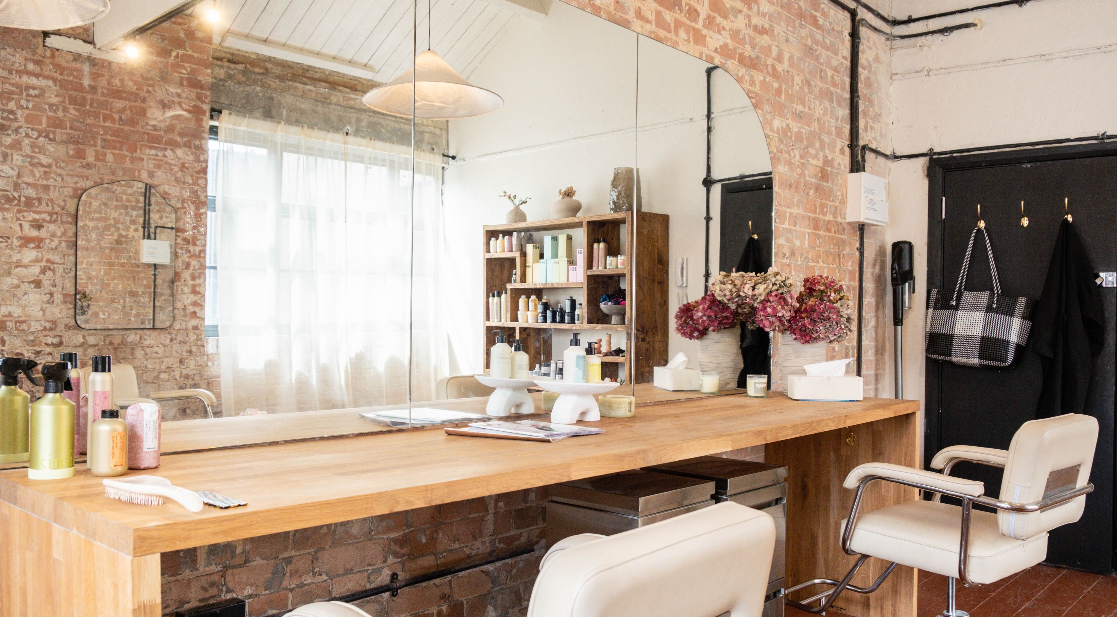 Elegant styling station at Fluff.Hackney, London, England, GB with plush chairs and modern decor.