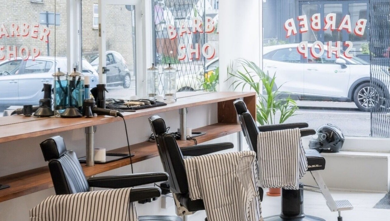 Interior of Project Barber in London, England, GB showcasing sleek chairs and modern styling tools.