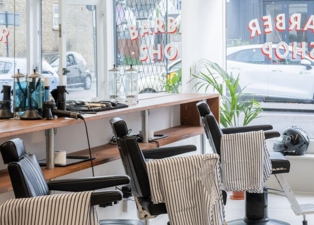 Interior of Project Barber in London, England, GB showcasing sleek chairs and modern styling tools.