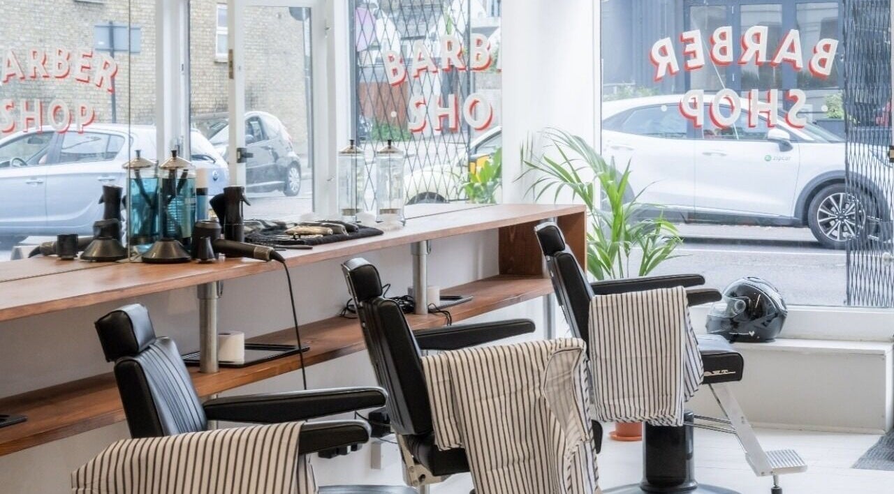 Interior of Project Barber in London, England, GB showcasing sleek chairs and modern styling tools.
