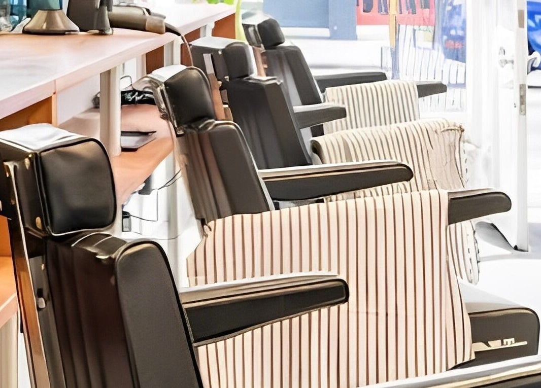 Barber chairs at Project Barber in London, England, GB, showcasing sleek leather design.