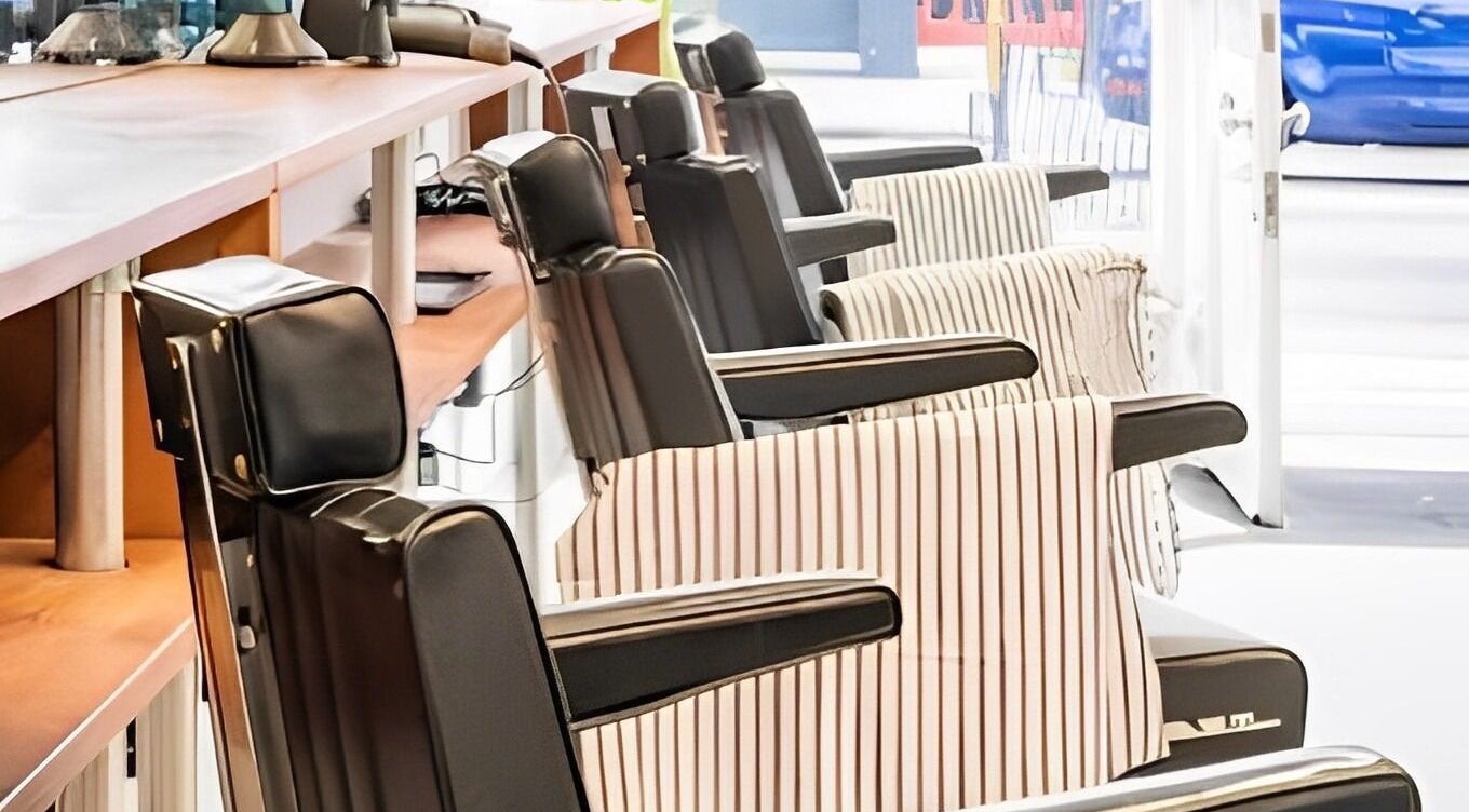 Barber chairs at Project Barber in London, England, GB, showcasing sleek leather design.