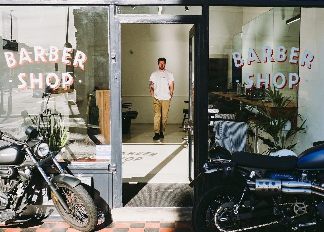 Project Barber entrance in London, England, GB, featuring shopfront and motorcycles parked outside.