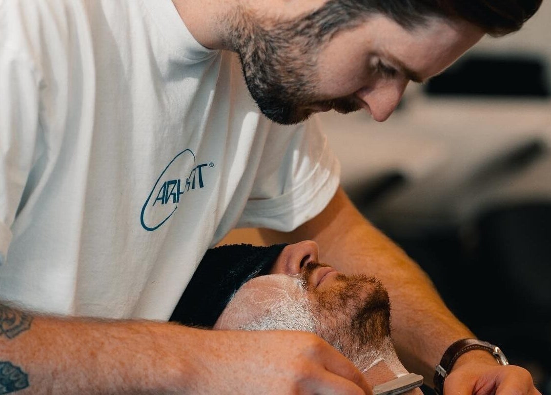Barber performing a precise shave at Project Barber, London, England, GB.