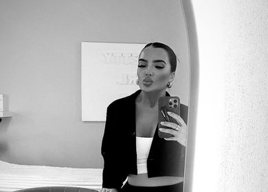 A stylish woman poses in Izabella Fivey Makeup, Coventry, England, GB with a chic mirror selfie.