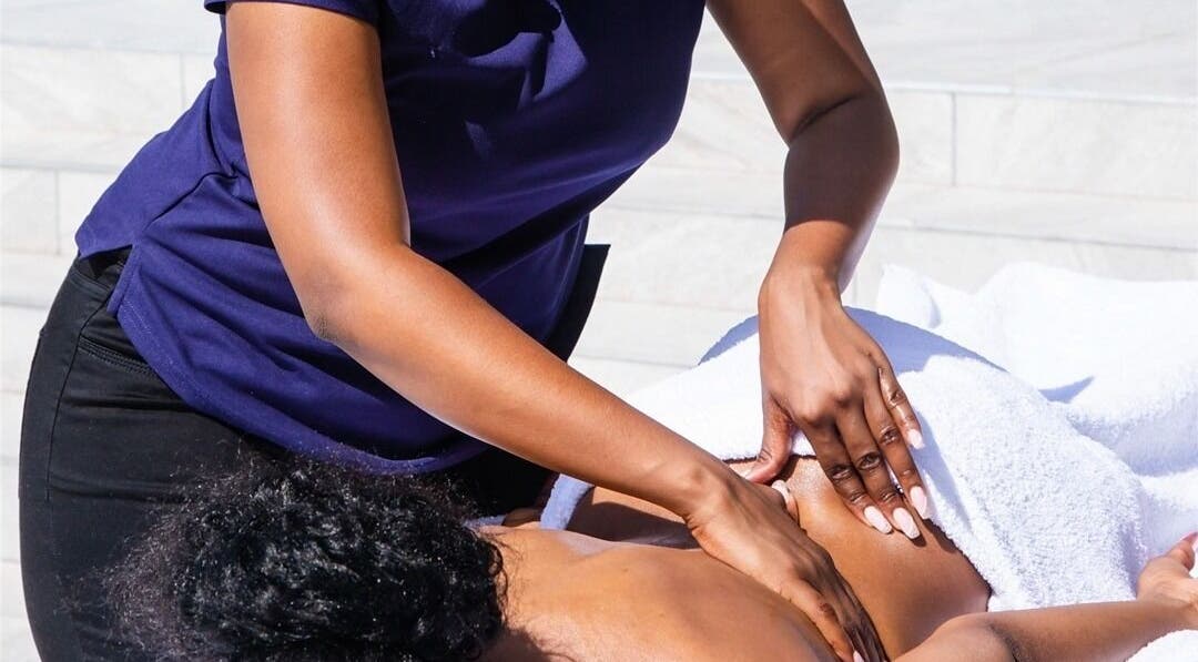 Therapist at Emihle Wellness & Mobile Spa in Berea, Kwazulu-natal, ZA performing a relaxing massage outdoors.