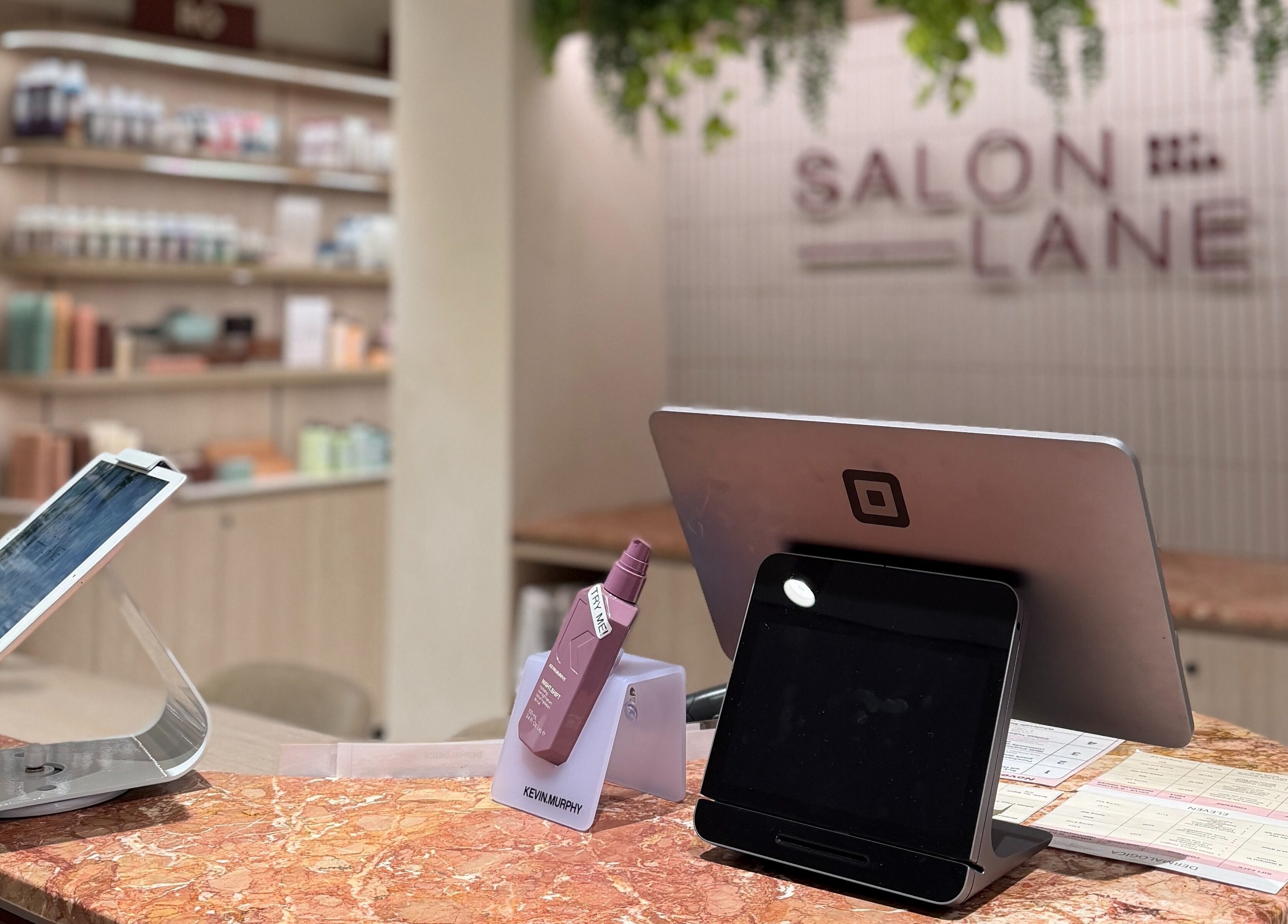 Reception desk at Zen Japanese Massage Platinum - Bondi Junction, with elegant decor and digital kiosks, New South Wales, AU.