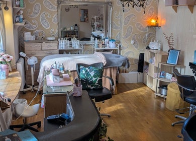Relaxing treatment room at Grecian Health and Beauty in Bishampton, England, GB, featuring a cozy and elegant design.