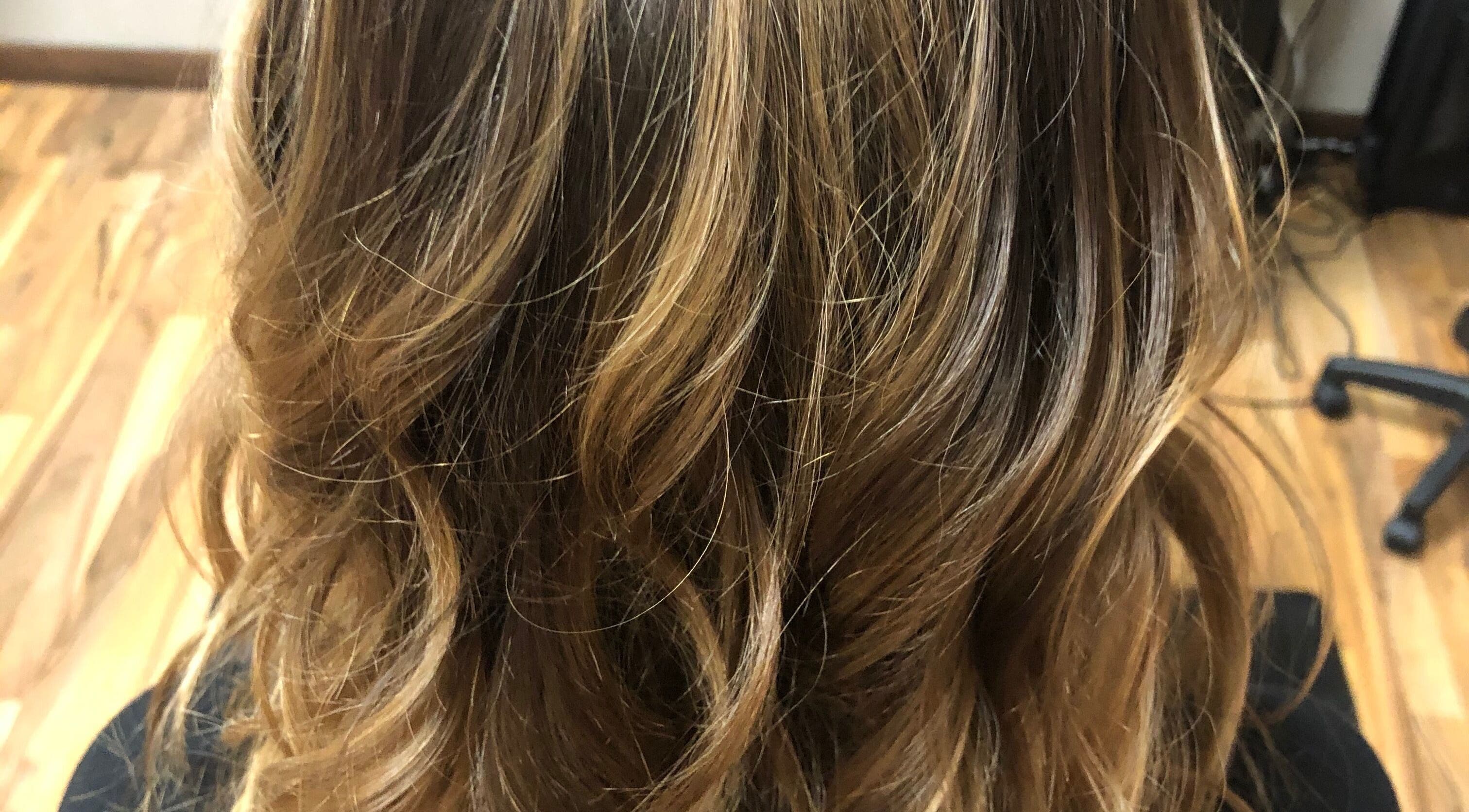 Golden brown wavy hairstyle at The Painted Strand Hair Salon, Kaukauna, Wisconsin, US.
