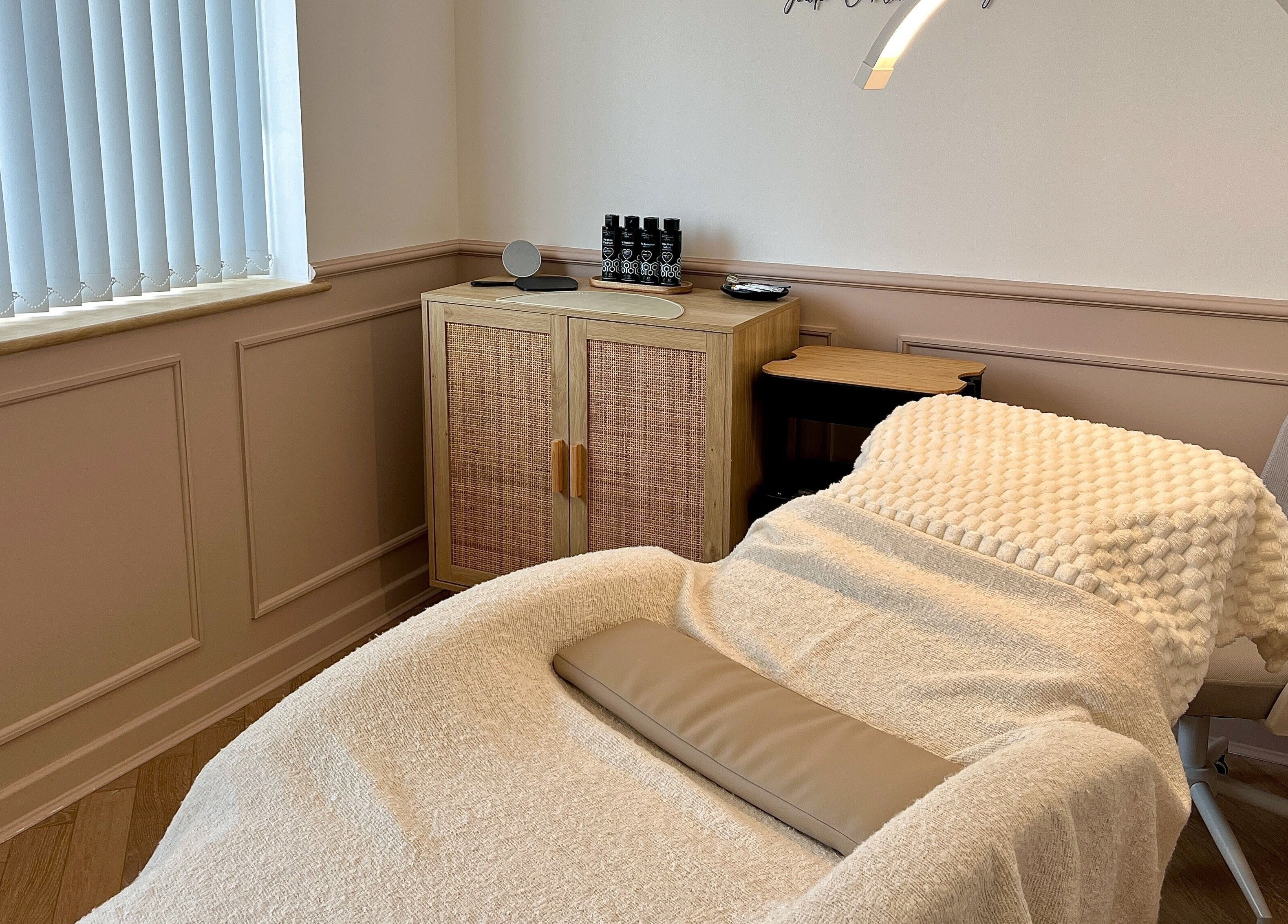 Relaxing treatment room at Jade Carla Beauty, Southport, England, GB with a plush bed and elegant decor.