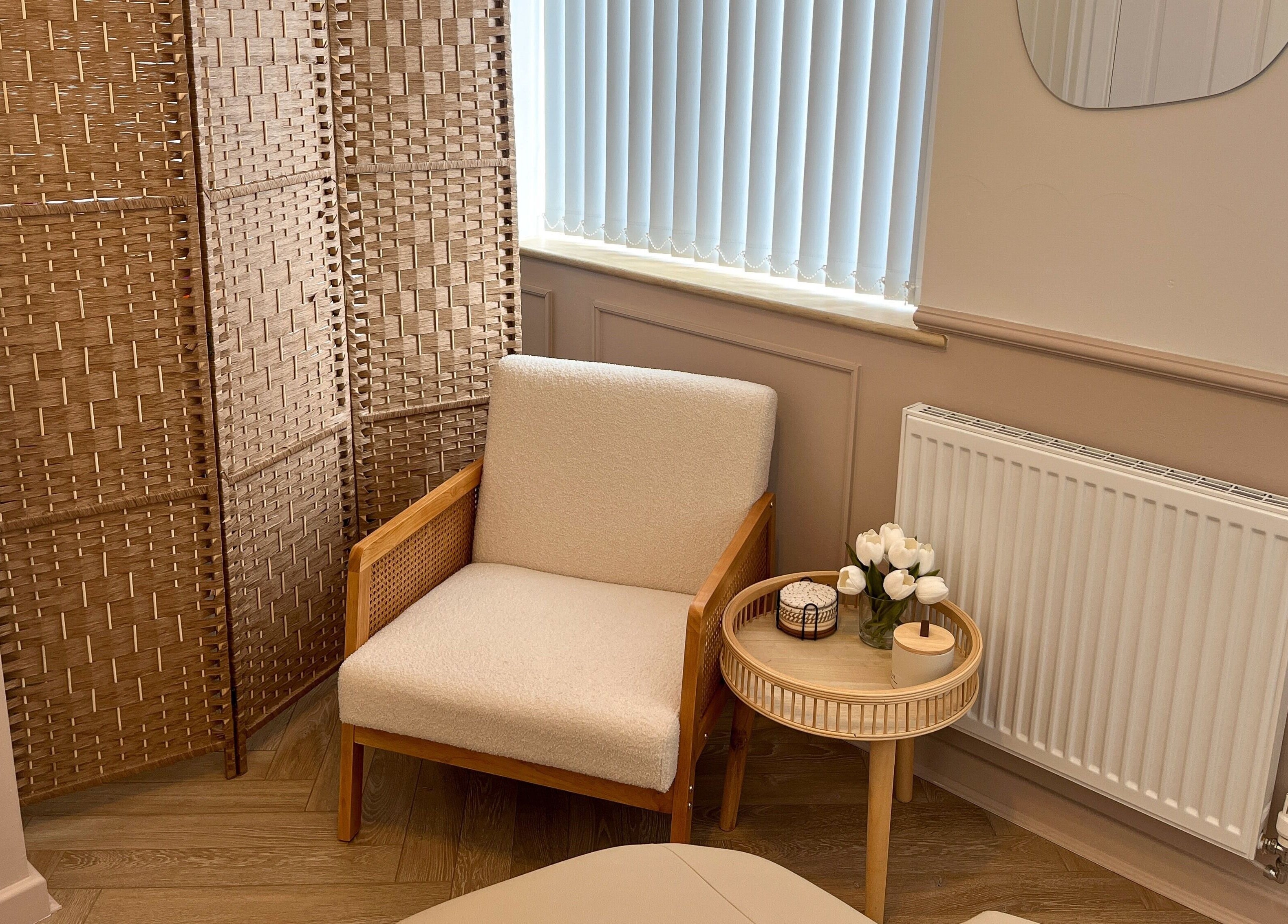 Relaxing waiting area at Jade Carla Beauty, Southport, England, GB with a comfy chair and decorative elements.