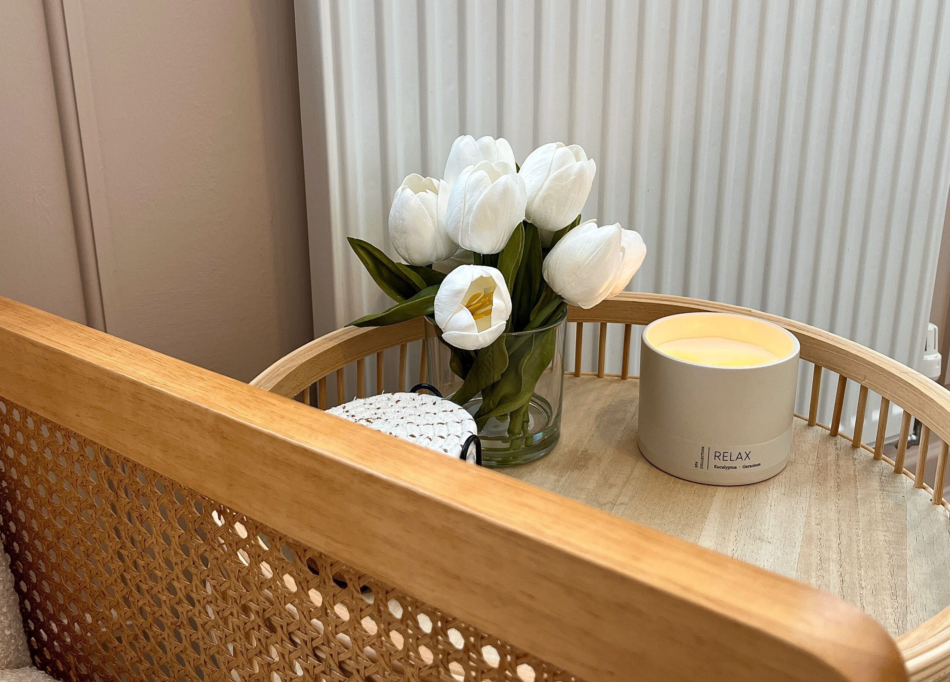 Cozy setting with white tulips and candle at Jade Carla Beauty, Southport, England, GB.