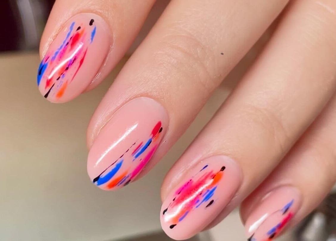 Colorful nail art at Iridescent, Guisborough, England, GB. Bright designs on oval shaped nails.