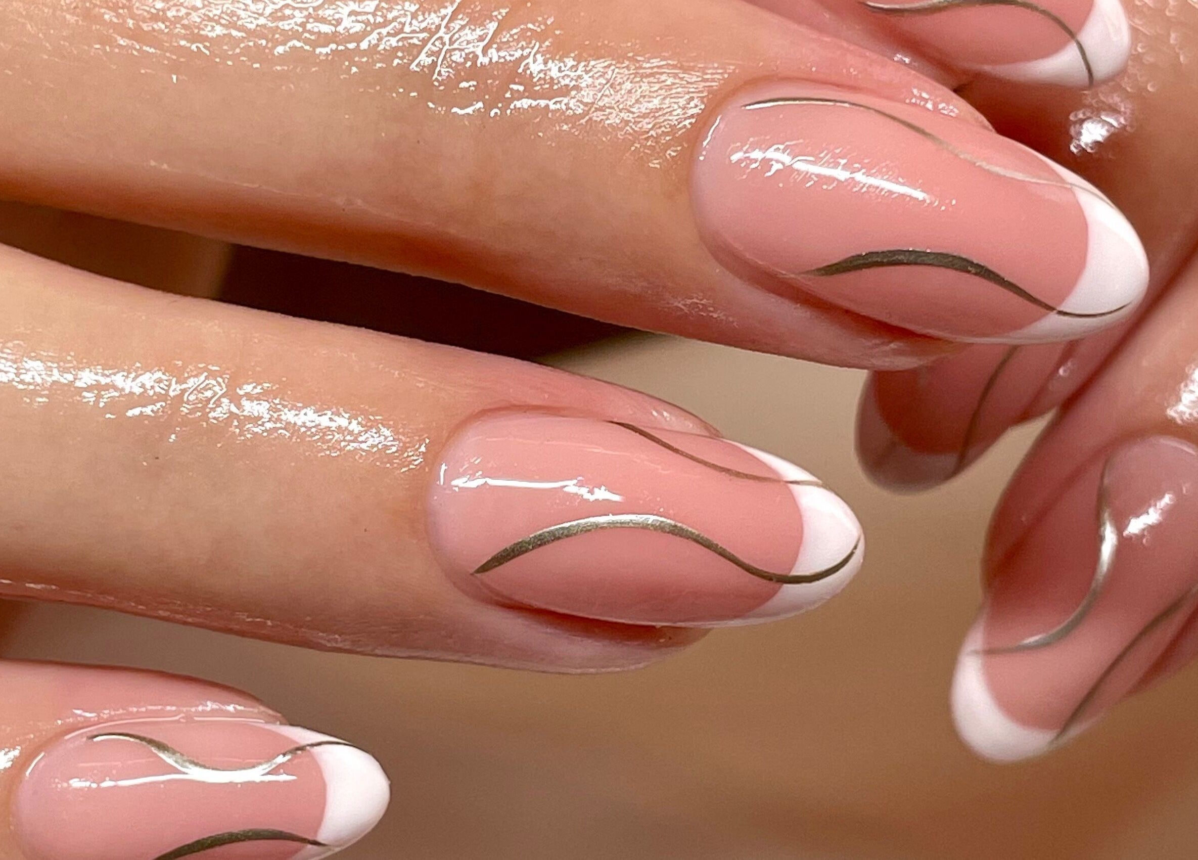Elegant nail art at Iridescent, Guisborough, England, GB. Featuring glossy pink nails with white and silver accents.