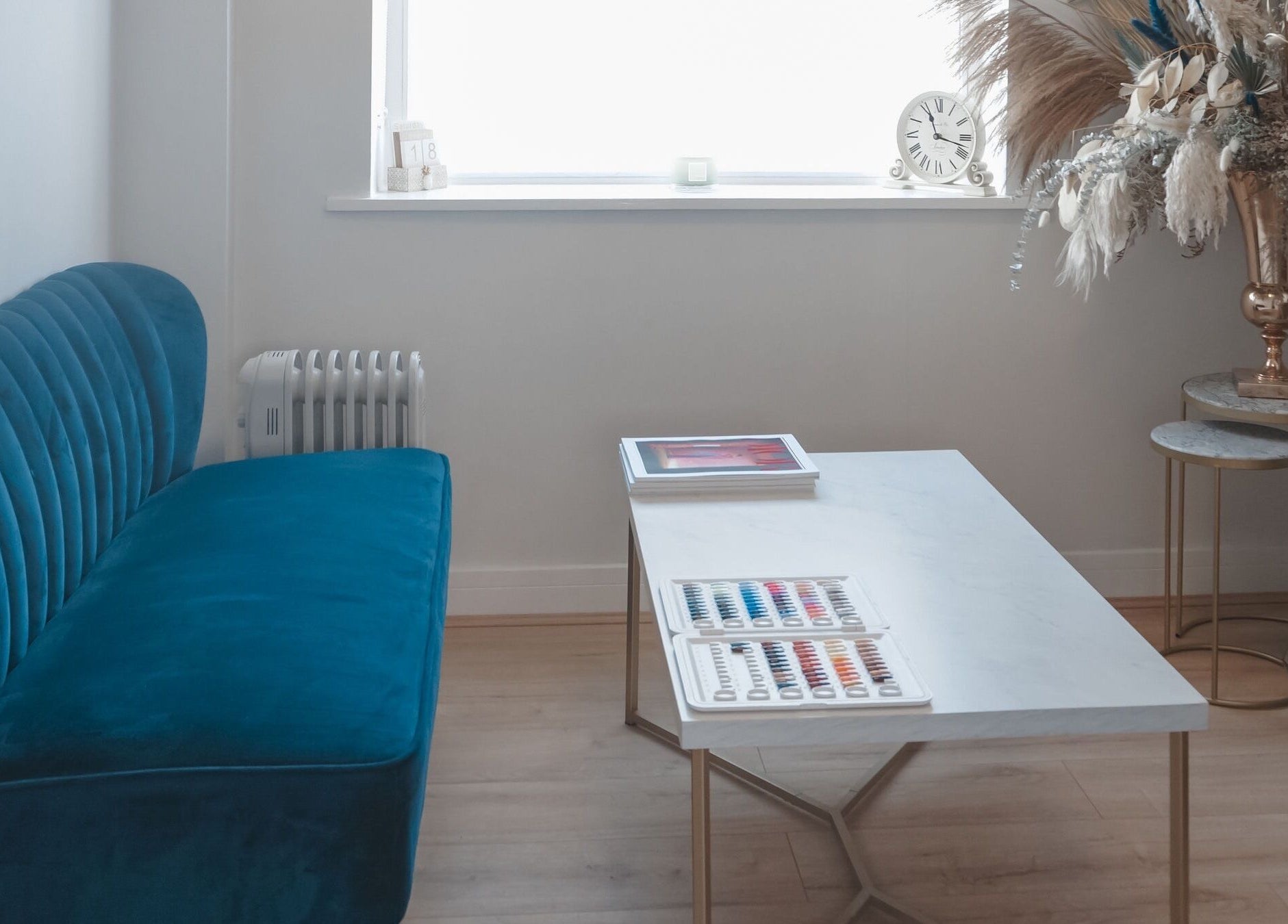 Elegant lounge with teal sofa at Iridescent, Guisborough, England, GB, showcasing modern decor.