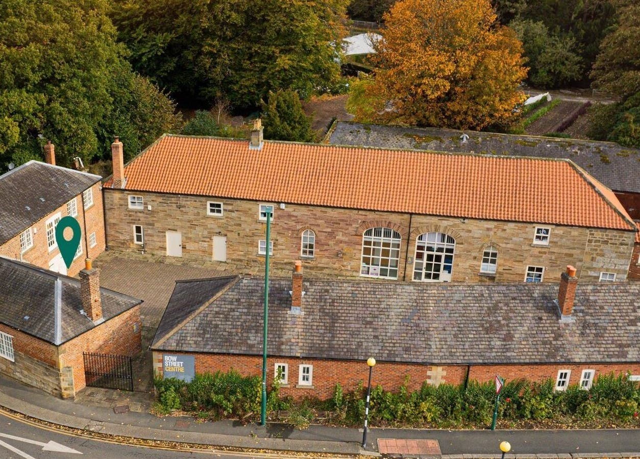 Aerial view of Iridescent beauty venue in Guisborough, England, GB showcasing brick architecture and surrounding greenery.