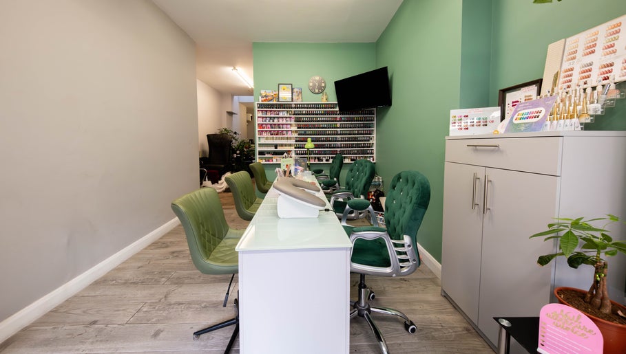 Beautique Salon's chic nail station with green chairs in London, England, GB.