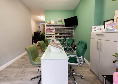 Beautique Salon's chic nail station with green chairs in London, England, GB.