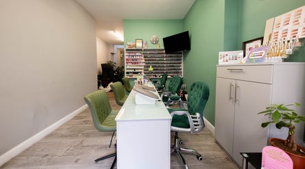 Beautique Salon's chic nail station with green chairs in London, England, GB.