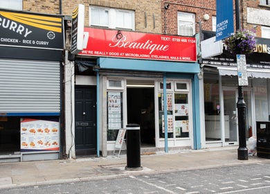 Exterior of Beautique Salon in London, England, GB showcasing the inviting storefront and vibrant signage.