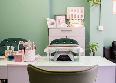 Modern manicure station at Beautique Salon in London, England, GB with elegant nail polish displays.