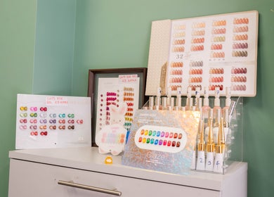 Nail polish color options at Beautique Salon, London, England, GB displayed on a stylish shelf.