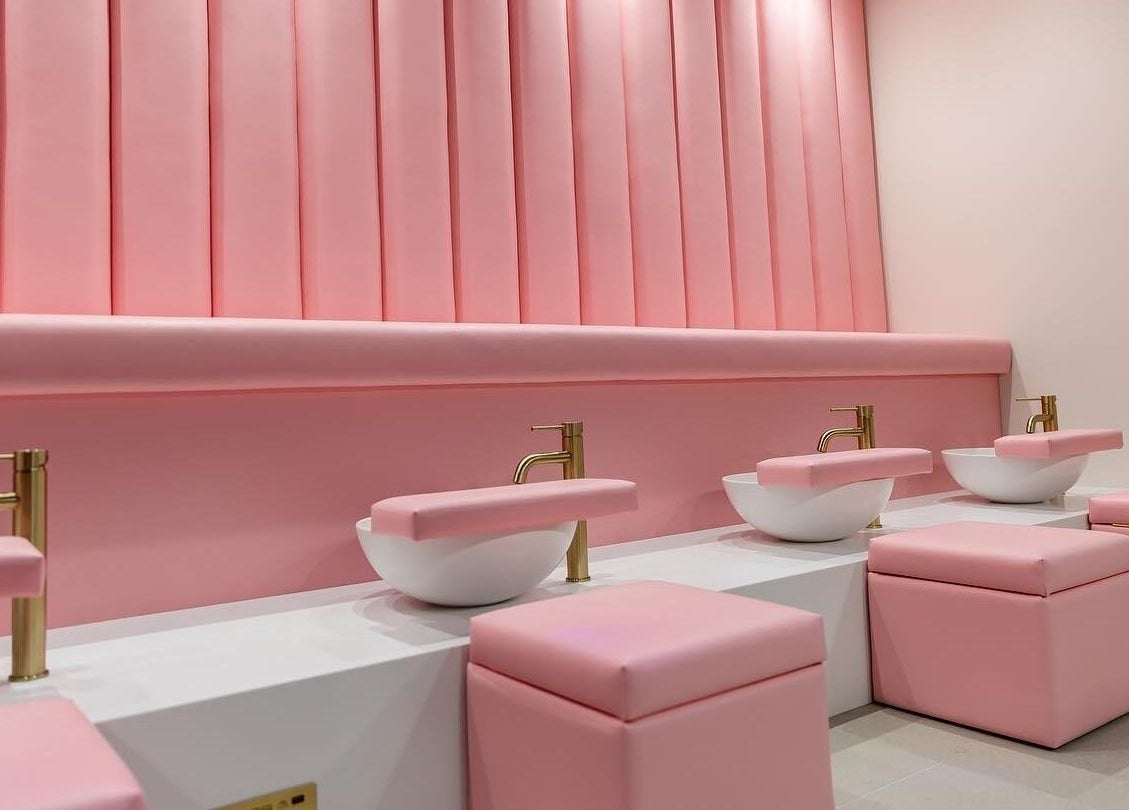 Luxurious pink pedicure station at Leon Beauty, London, GB, featuring chic seating and gold fixtures.
