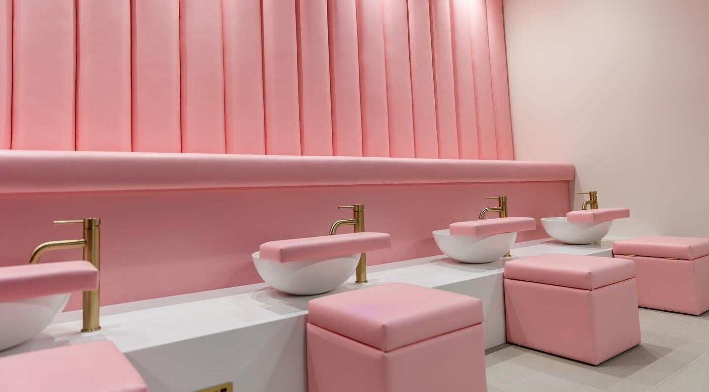 Luxurious pink pedicure station at Leon Beauty, London, GB, featuring chic seating and gold fixtures.