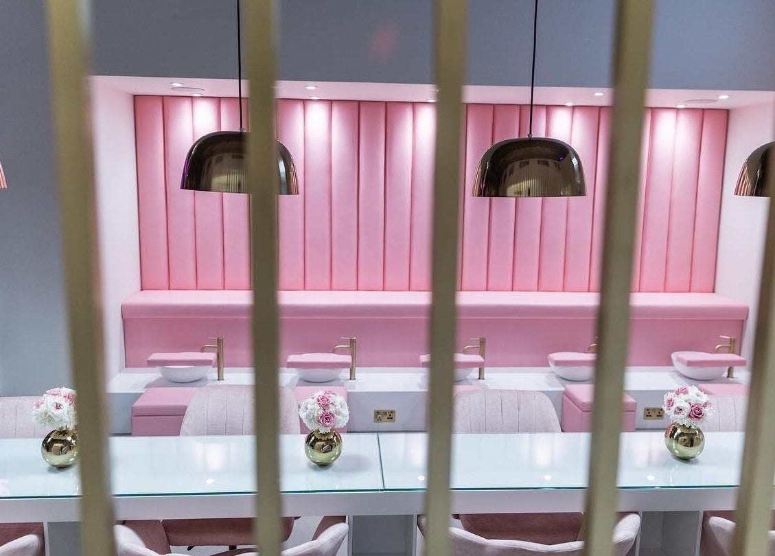 Chic pink interior of Leon Beauty, a luxurious venue in London, GB, featuring modern decor and sleek amenities.