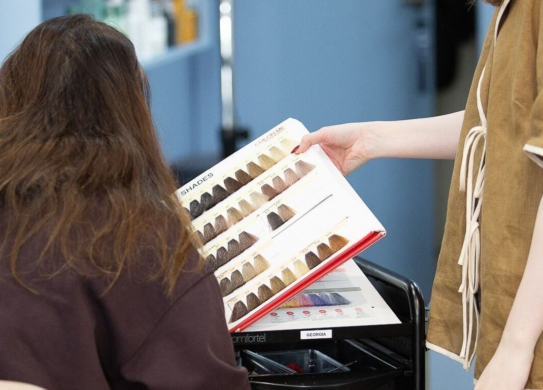 Client choosing hair color at Bhãva Salon in Teneriffe, Queensland, AU.