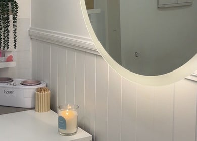 Bouttell Beauty serene treatment room with candle and mirror in North Lakes, Queensland, AU.