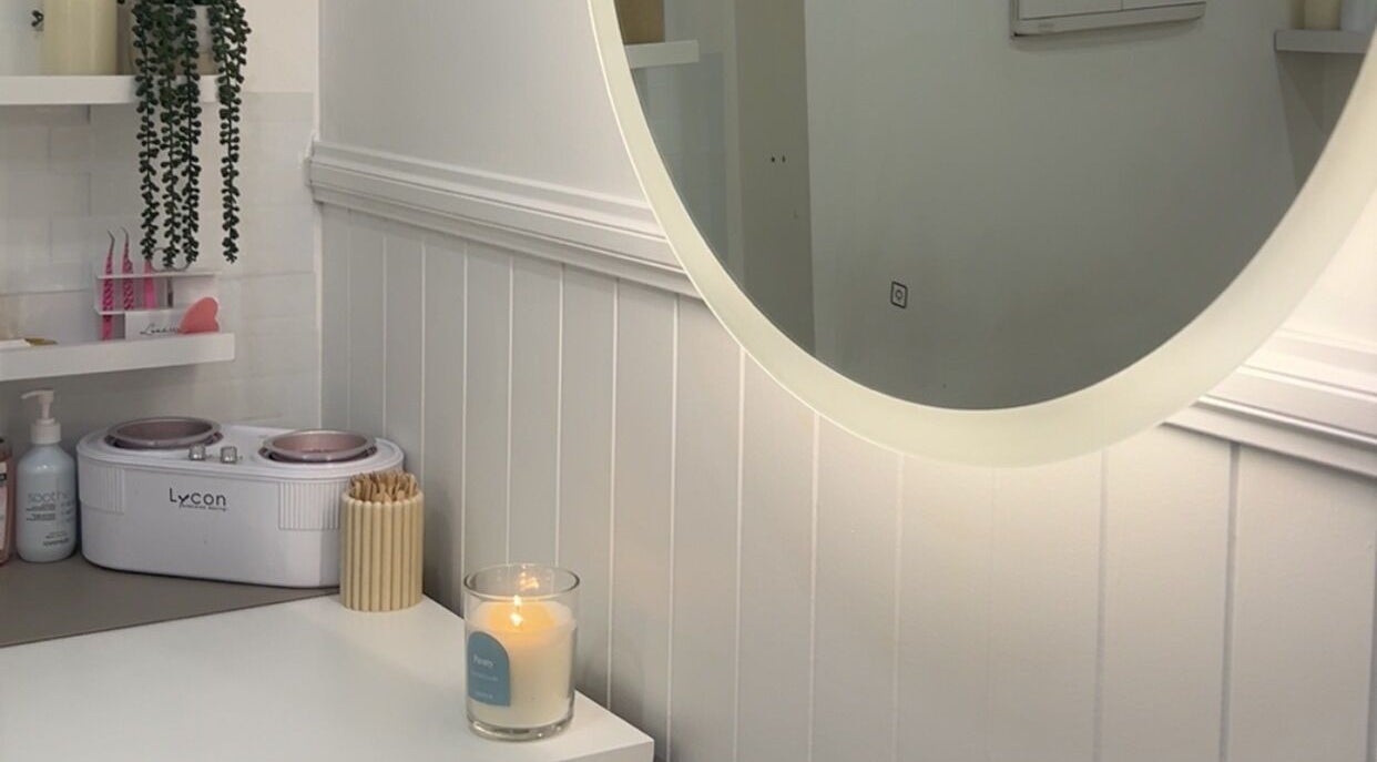 Bouttell Beauty serene treatment room with candle and mirror in North Lakes, Queensland, AU.