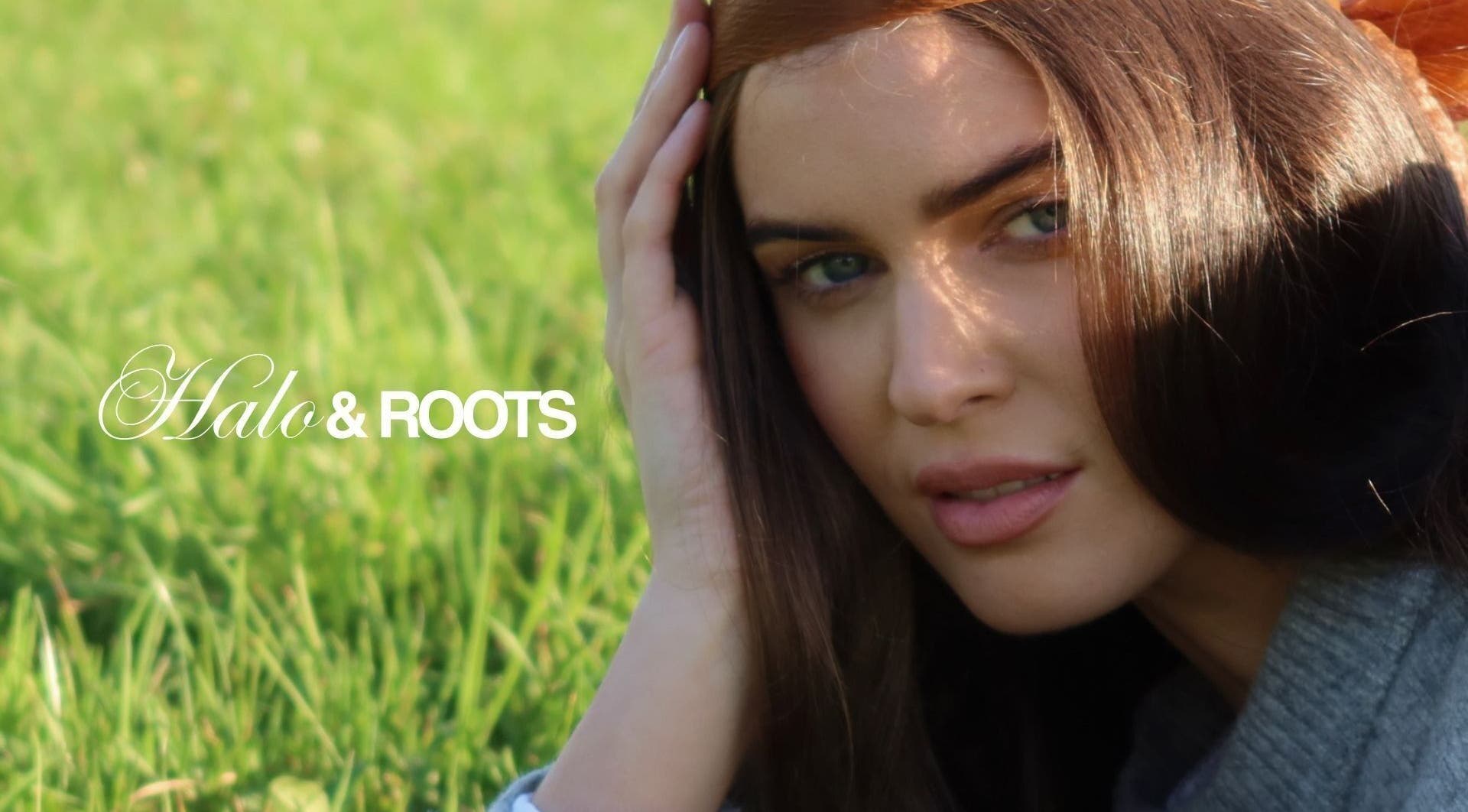 Close-up of a serene woman at Halo & Roots in Kildare, County Kildare, IE with lush green grass background.
