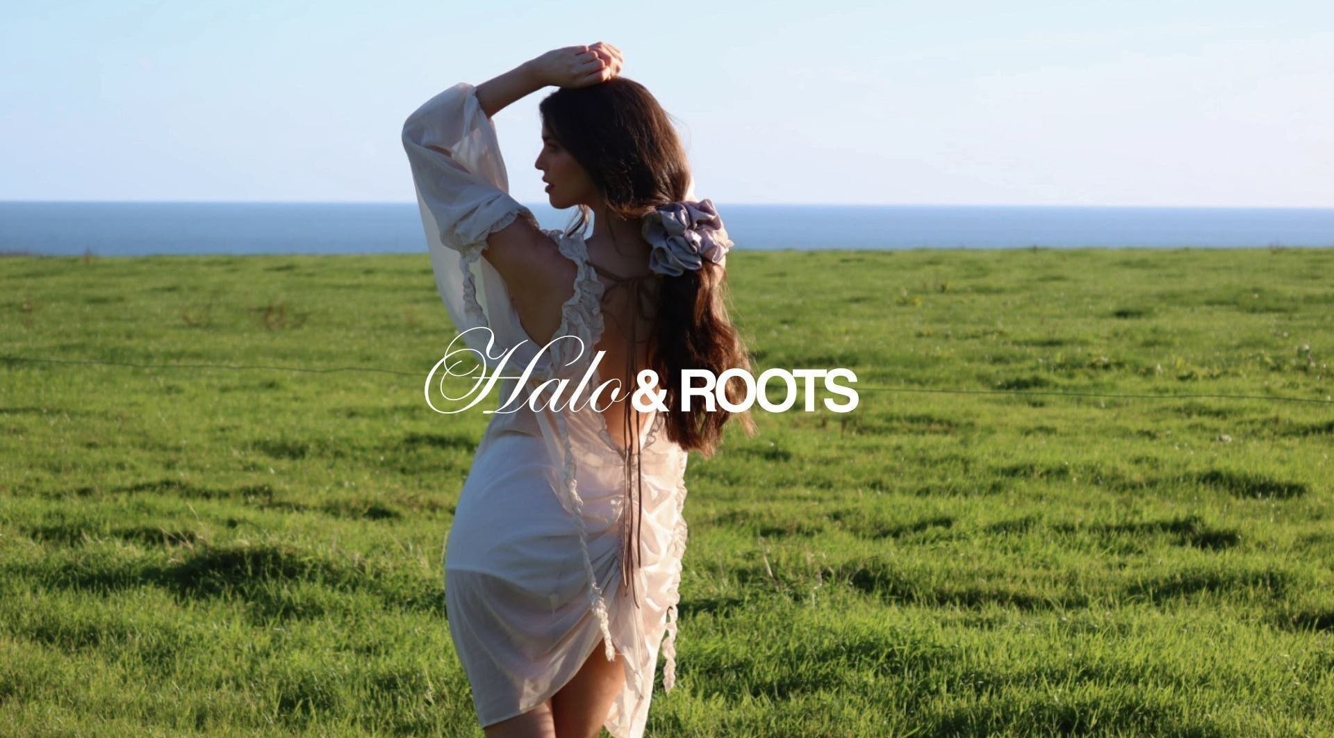 Woman in white dress with flower in hair at Halo & Roots, Kildare, County Kildare, IE, overlooking the sea.