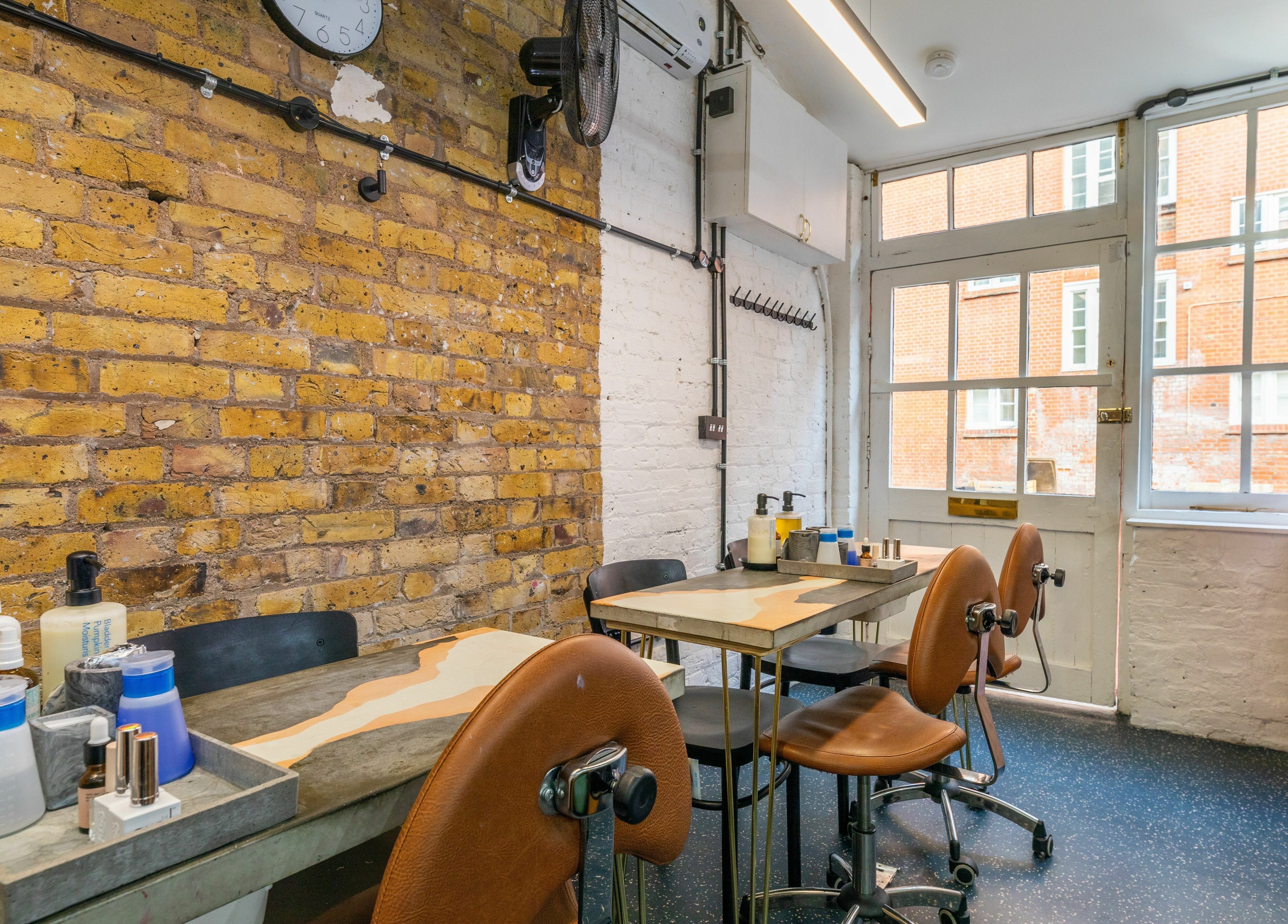 Modern nail salon interior at Shoreditch Nails Shoreditch, London, England, GB with exposed brick and chic decor.