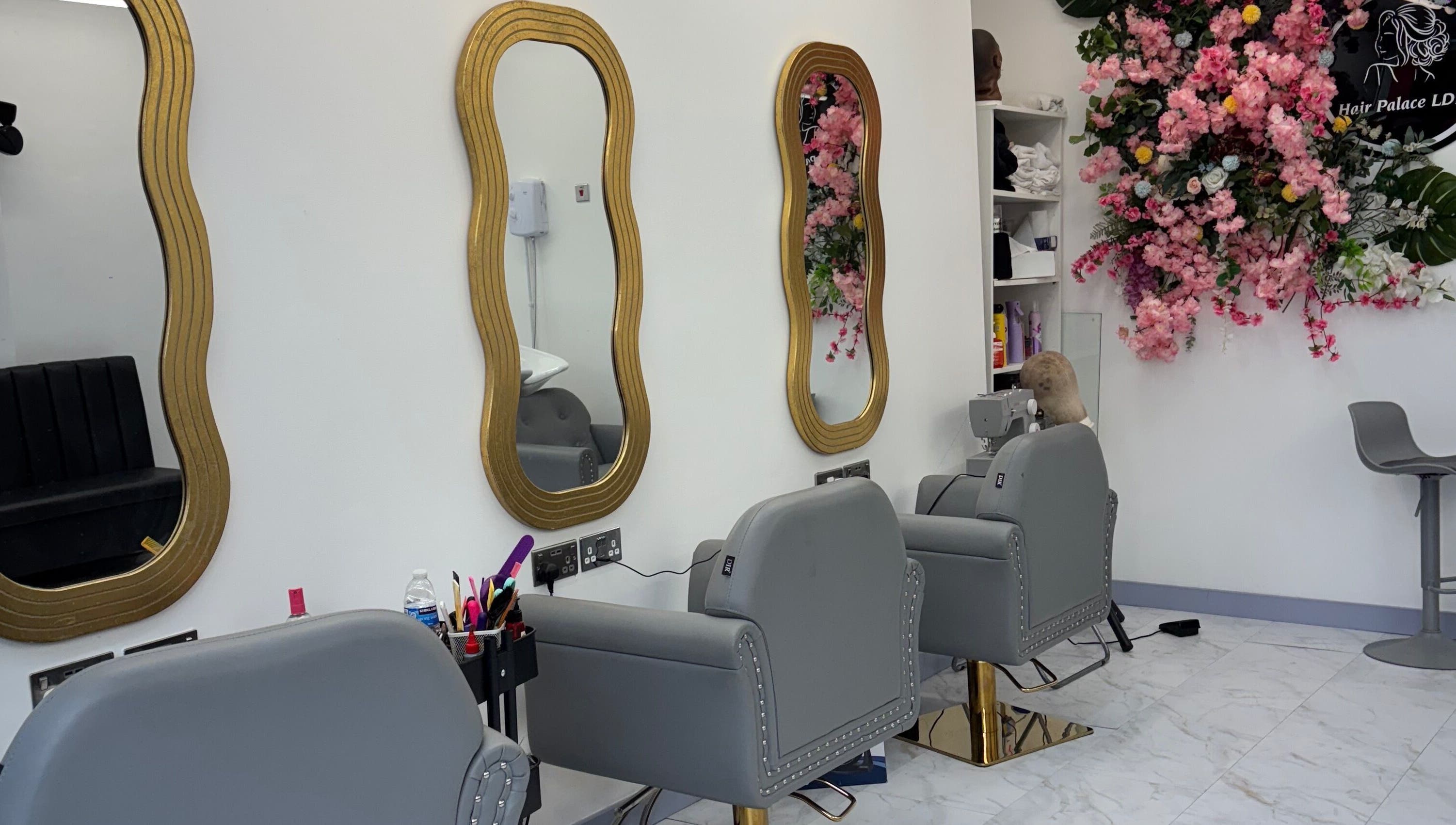 Stylish salon interior at Hair Palace LDN, Peckham rye, England, GB with ornate mirrors and floral decor.