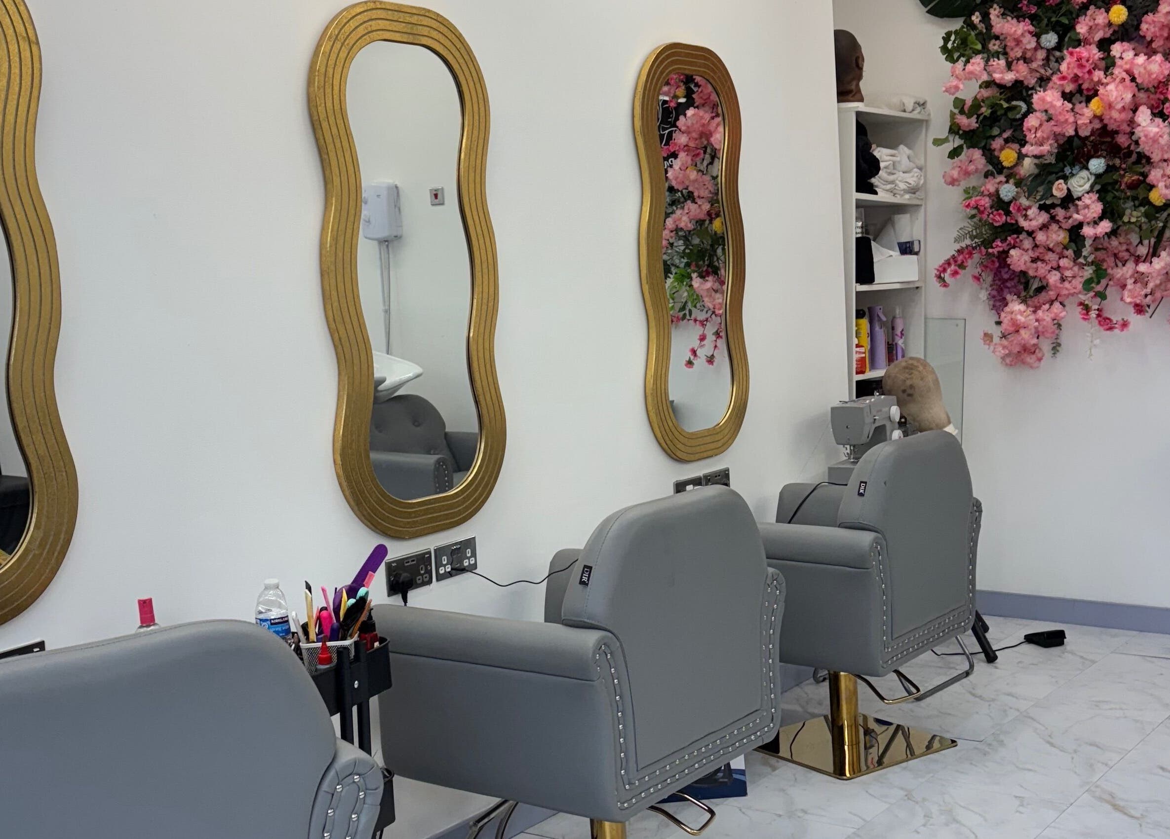 Stylish salon interior at Hair Palace LDN, Peckham rye, England, GB with ornate mirrors and floral decor.